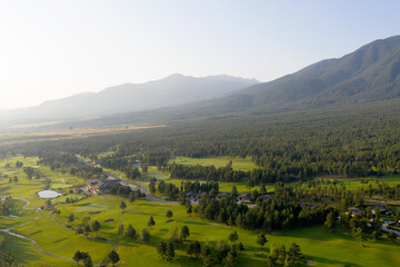 Obraz premium Aerial view from a drone. Stunning mountain views, hotels in the ski resort of Bansko, green golf courses in the morning at dawn. Travel and vacation concept