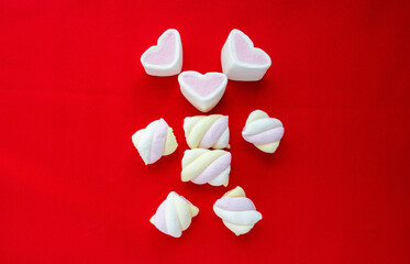 Colorful marshmallow candy isolated on red background