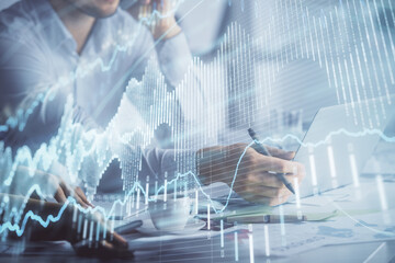 Double exposure of man and woman working together and financial graph hologram. Business concept. Computer background.