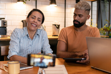 Lovely brazilian female boss with big smile presenting project at meeting online in office workspace Teamwork, corporate, planning, strategy concept..