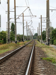 Fototapeta na wymiar Railway or railroad tracks for train transportation. Lower angle view of empty train tracks. Curving Railway.
