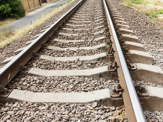 Empty railroad tracks go into the distance, close up image