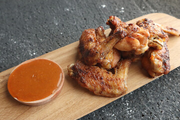 Delicious chicken wings, baked or fried chicken wings served with hot spicy  barbeque sauce
