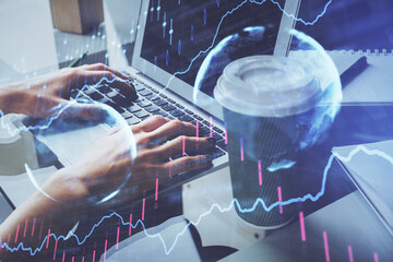 Double exposure of woman hands typing on computer and forex chart hologram drawing. Stock market invest concept.