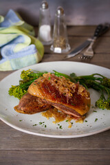 Roast duck breast fillets with vegetables on plate. vertical image