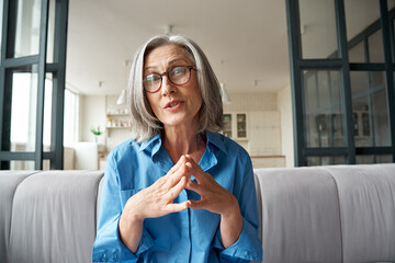 Mature 60s old woman online teacher, remote tutor, distance coach therapist businesswoman talking...