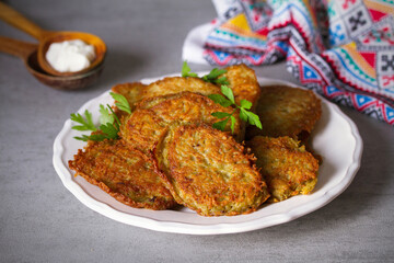 Potato cakes. Vegetable fritters, pancakes, latkes - dish consisting of pan fried shredded potatoes.