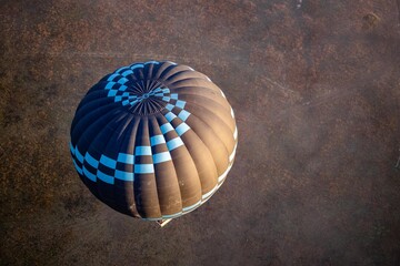 hot air balloon from above as it drifts away