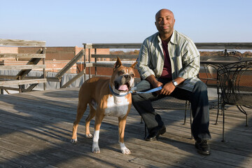 African man and dog on deck - dogs