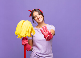 young pretty woman smiling and looking friendly, showing number three or third with hand forward,...