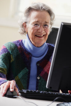 Elderly woman using a computer
