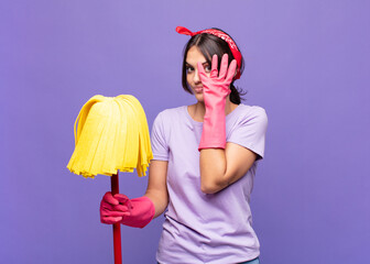 young pretty woman feeling scared or embarrassed, peeking or spying with eyes half-covered with...