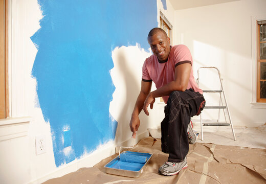 African American man painting wall