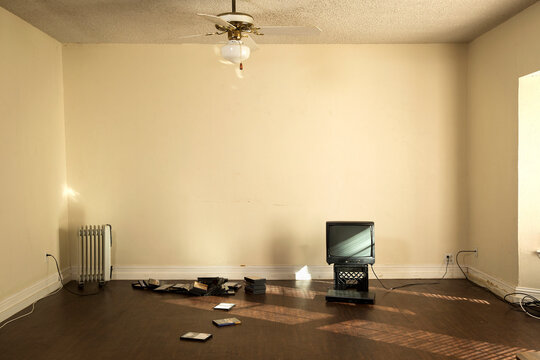 Television on crate in barren apartment