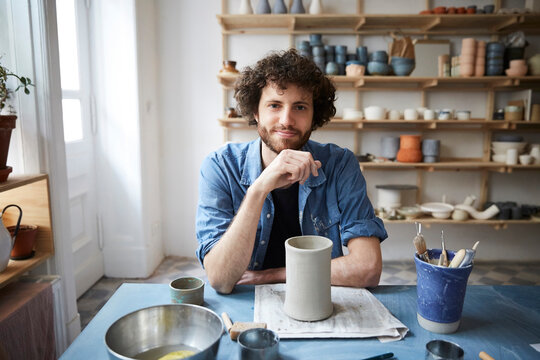 Portrait of mid adult man sitting in pottery class