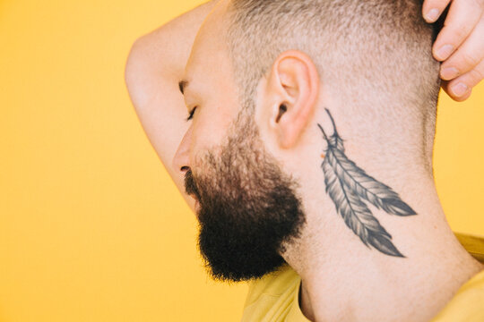 Close up of man with eyes closed showing tattoo