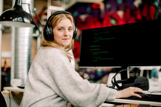 Portrait of female computer programmer sitting in office