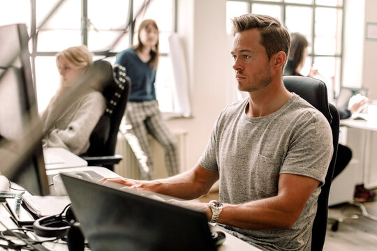 Male entrepreneur working on computer at workplace