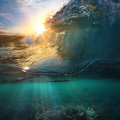 Tropical paradise template with sunlight. Ocean surfing wave breaking and coral reef underwater