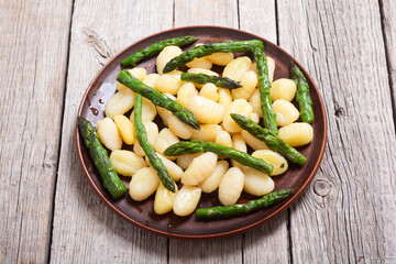 Italian homemade potatoes gnocchi with asparagus