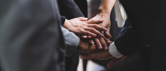 Large business team showing unity with their hands together, business success concept.