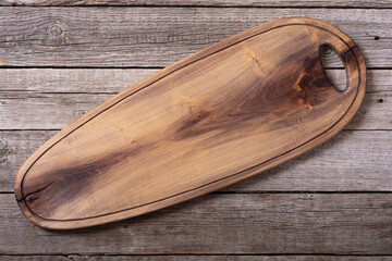 Rustic cutting board on wooden background