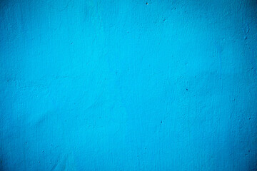 Blue paint painted on rough wall background