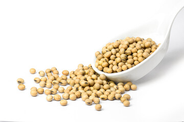 Soybeans in ceramic spoon isolated on white background. Selective focus.