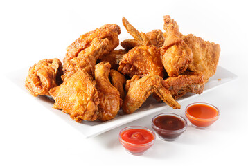 Platter of family sized fried chicken with three sauces on white background with copy space