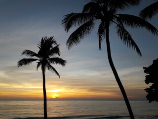 Maceió - Alagoas - Brazil - March 22, 2019 - Sunrise on the beach between coconut palms