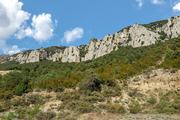 Fototapeta na wymiar Hills with rock walls and vegetation around in the interior of Spain