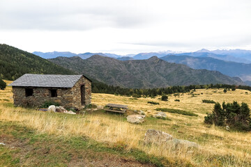 Stone shelter, with a general view of the mountains in the background, Alt Pirineu Natural Park, province of Lérida, autonomous community of Catalonia