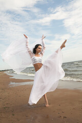 Fototapeta na wymiar woman dancing on the beach