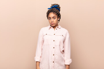 young afro woman feeling sad and whiney with an unhappy look, crying with a negative and frustrated...