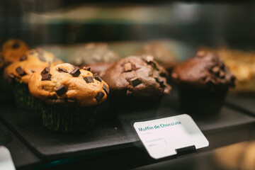 chocolate chip muffins in a showcase