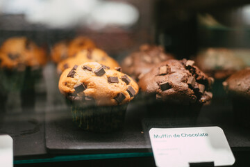 chocolate chip muffins in a showcase
