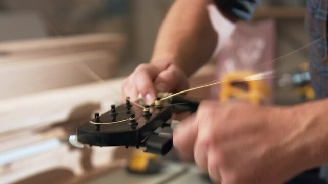 Winding up new strings on a guitar that was just fixed 