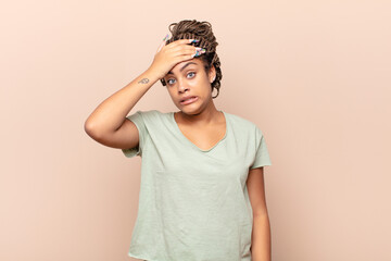 young afro woman panicking over a forgotten deadline, feeling stressed, having to cover up a mess...