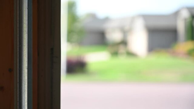 Side guide of garage door being shut.  Sound of squeaking wheels.  