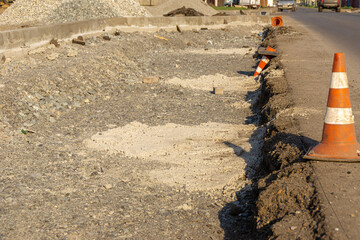 curb formation and traffic cones at the edge of the carriageway, selective focus