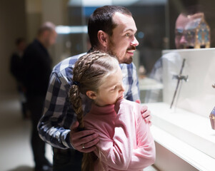 Young father and daughter enjoying expositions in museum