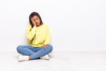 young afro woman feeling bored, frustrated and sleepy after a tiresome, dull and tedious task,...