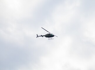Fototapeta na wymiar Helicopter flying high over Sydney harbour Australia