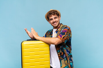 young man feeling happy and successful, smiling and clapping hands, saying congratulations with an...