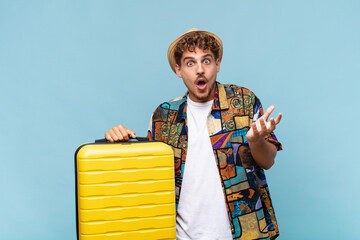 young man open-mouthed and amazed, shocked and astonished with an unbelievable surprise. holidays...