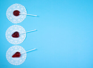 Delicious sweet candy on a stick. Lollipops on sticks in the form of berries