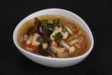 Thai style soup with meat and mushrooms