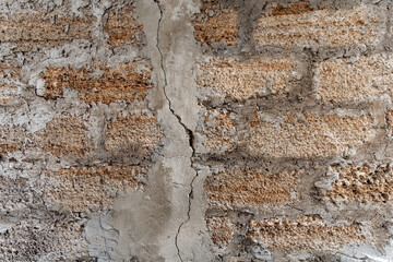 Rough texture of a brick wall made of shells. There is a crack in the middle of the wall.