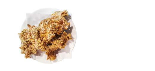 Top view Photography of Yummy Fried Chickens on A White Dish over A Brown Wooden Table.