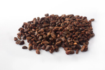 Heap of pine nuts on a white background.